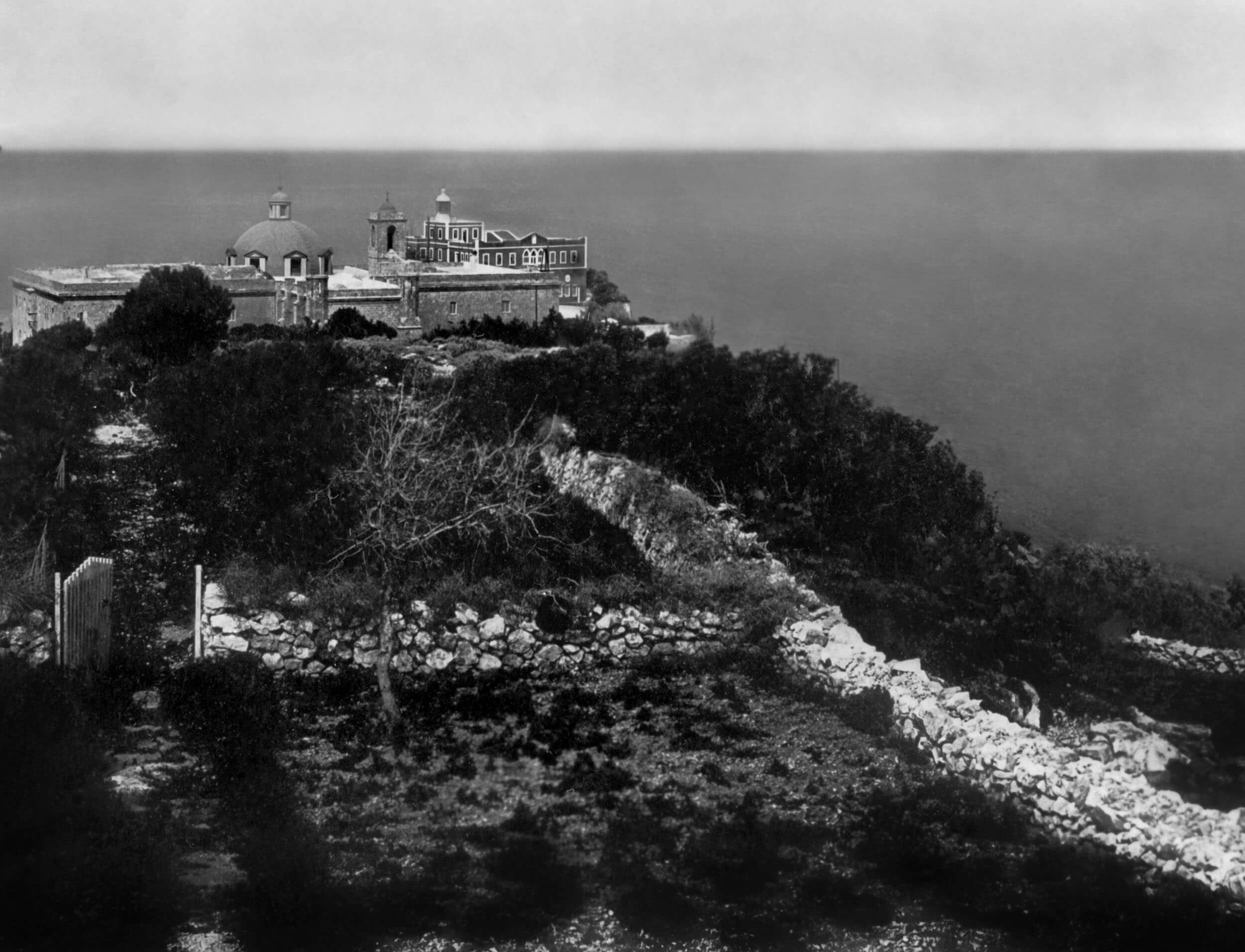 Archival photograph — coastal monastery at dusk