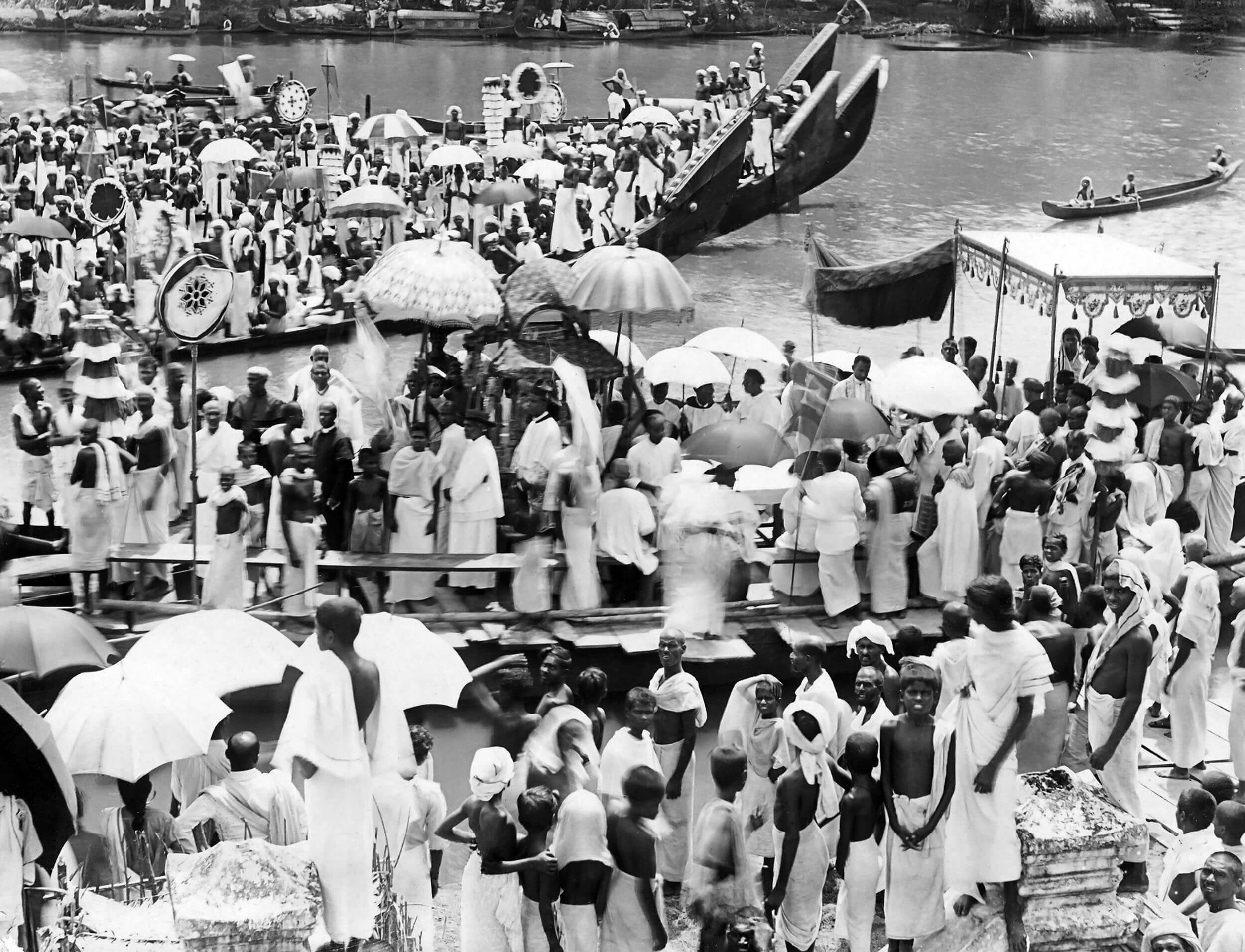 Archival photograph — riverside religious procession with boats, mission in India