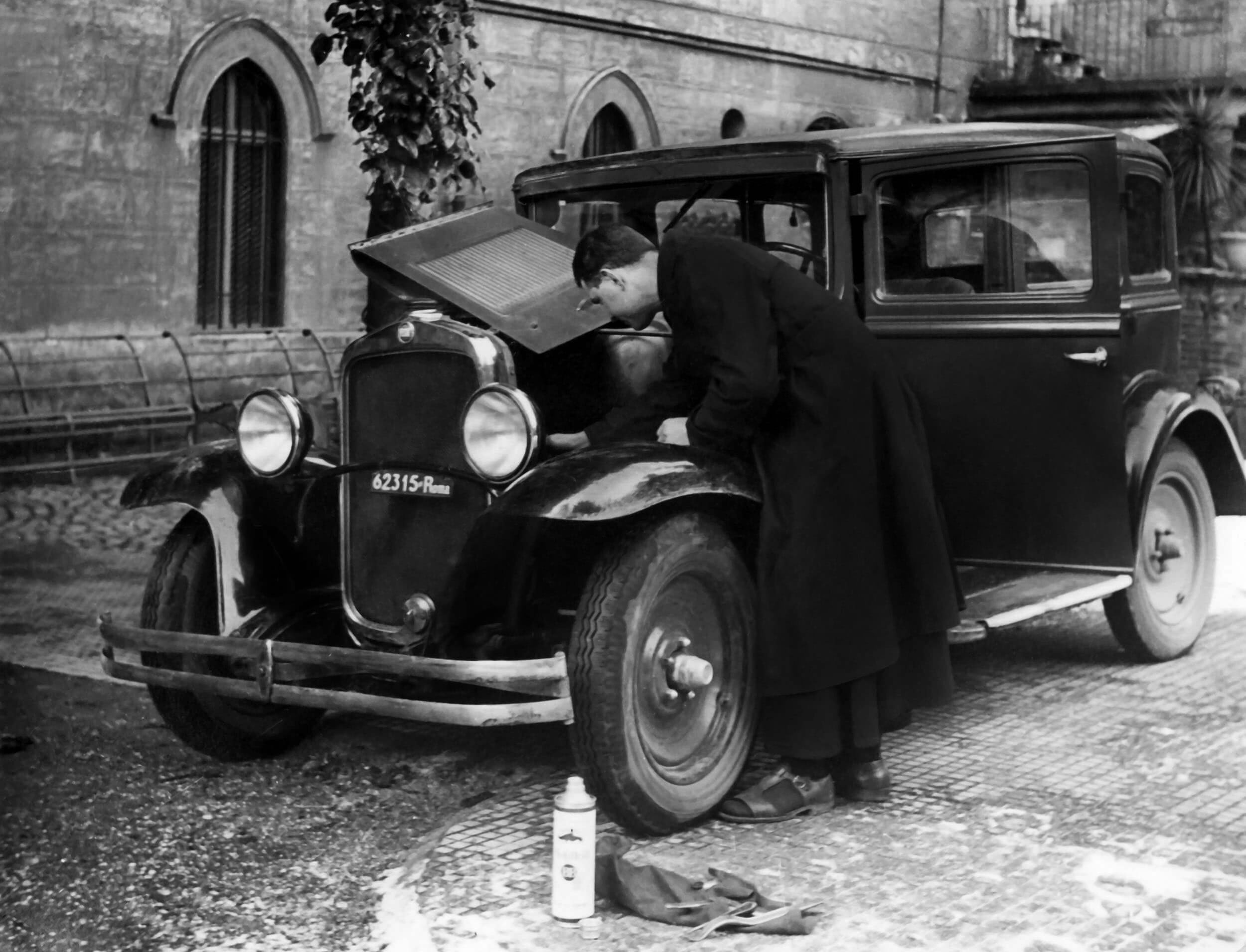 Archival photograph — car parked at a building entrance