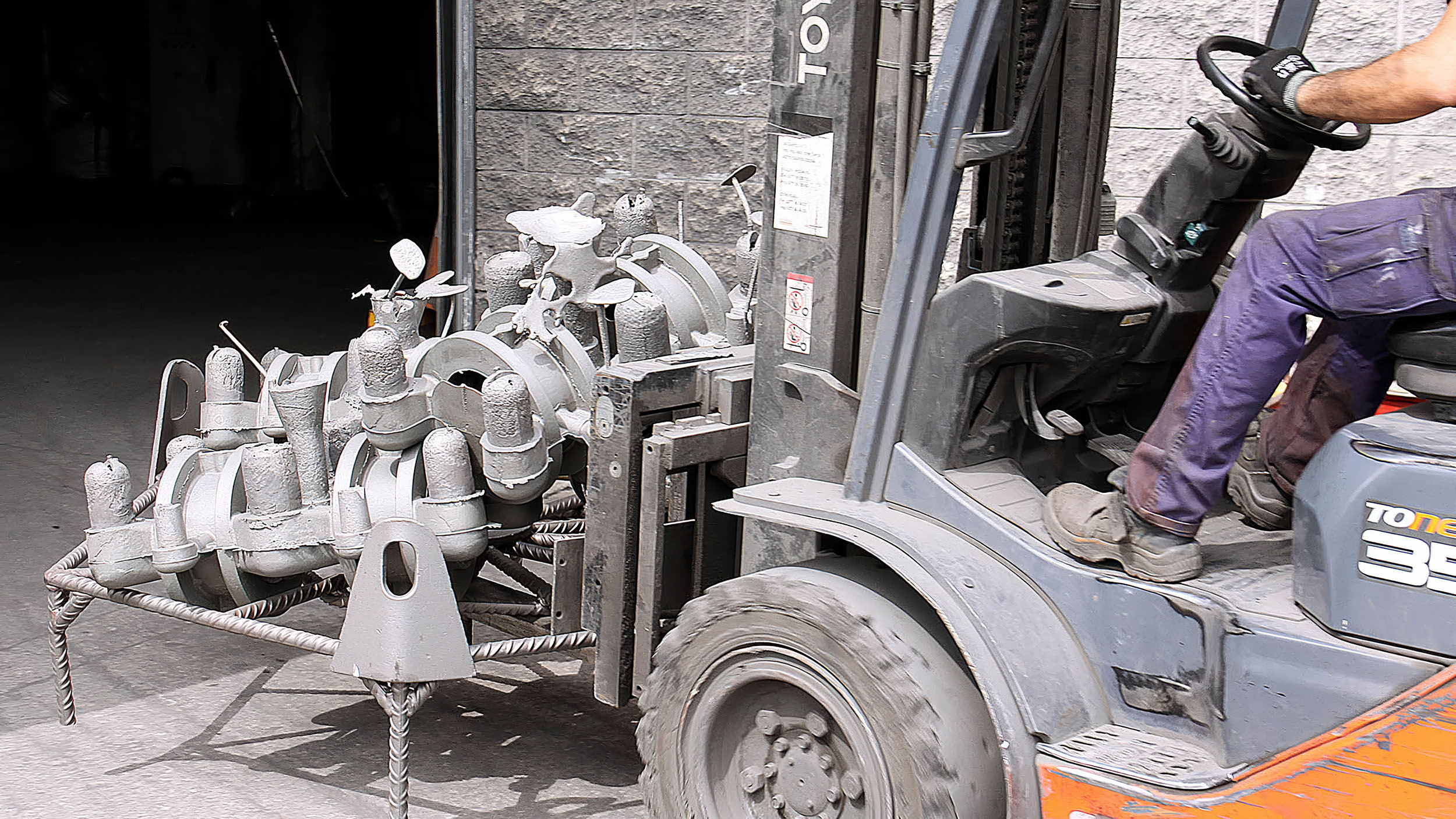 Forklift transporting a cast valve assembly