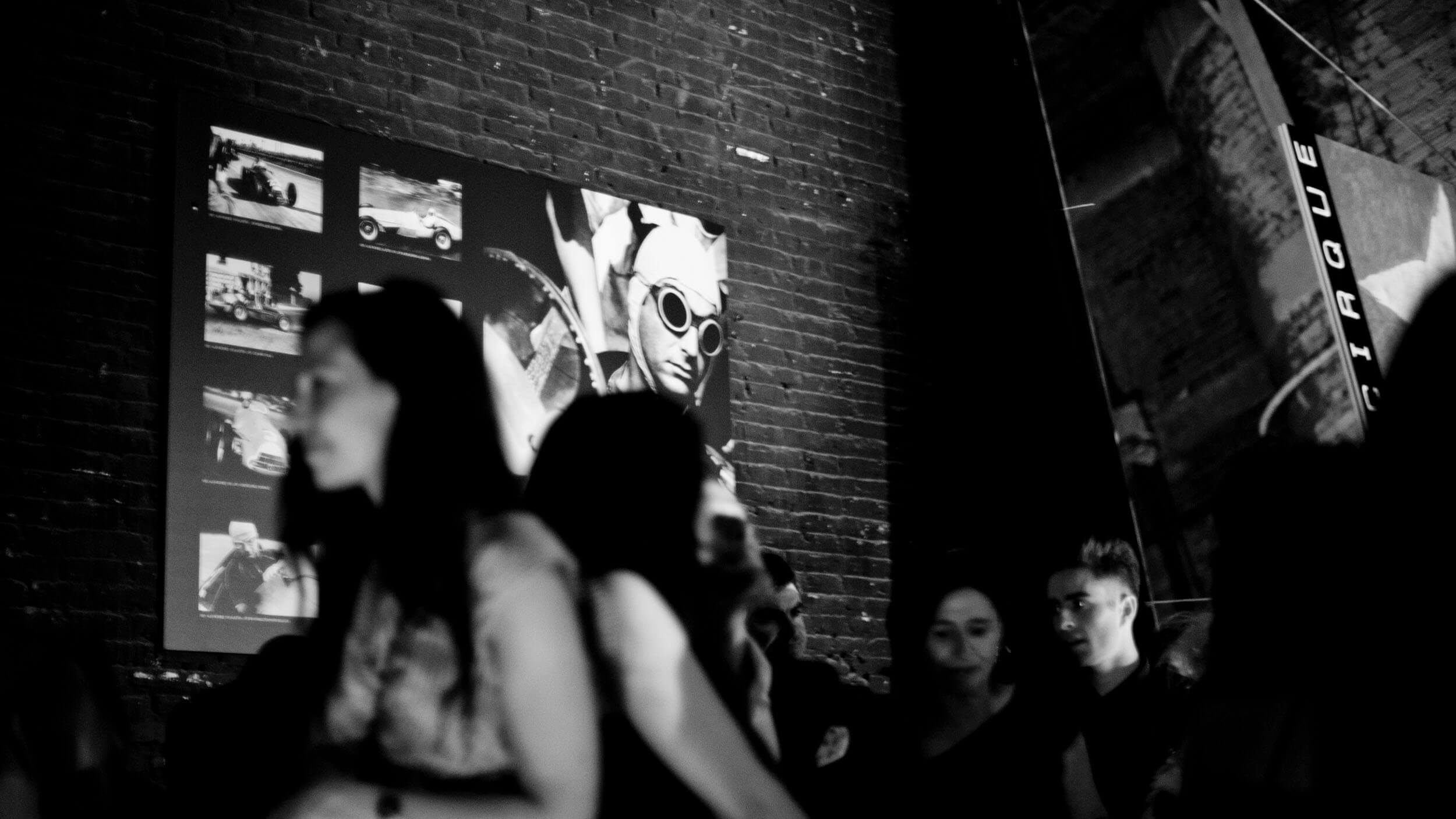 Archive photography displayed on brick wall, Le Cirque event