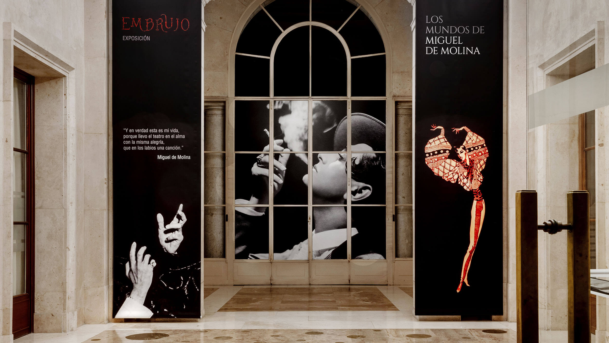 Embrujo — Los Mundos de Miguel de Molina, entrance banners flanking arched window