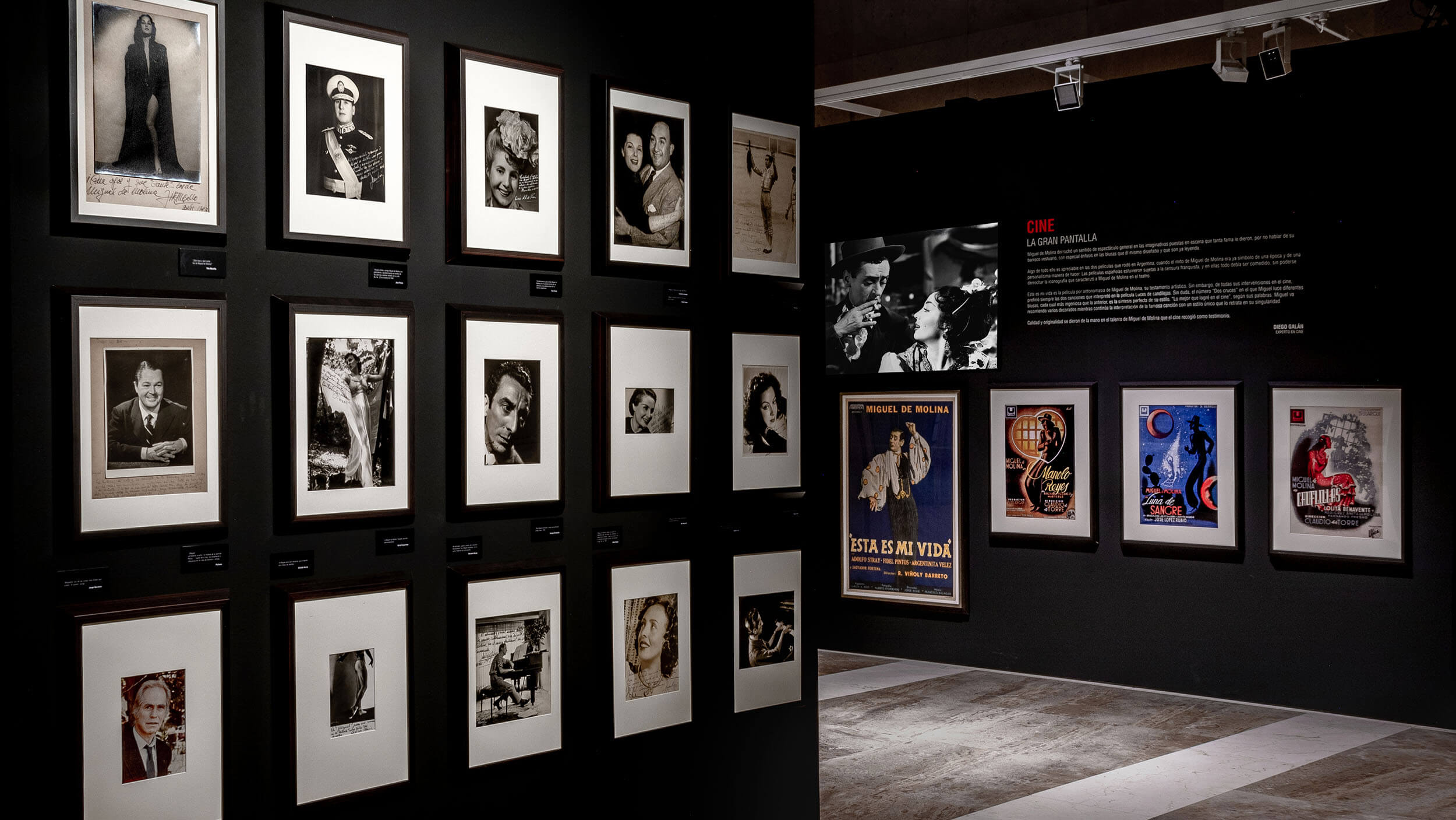 Portrait gallery wall and poster archive, black exhibition space